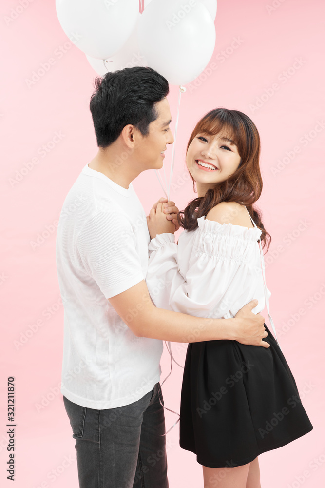 Portrait of attractive stylish couple in casual outfits, men embracing lover, woman looking at camera. True feelings concept Portrait of attractive stylish couple in casual outfits, men embracing lover, woman looking at camera. True feelings concept