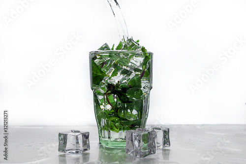 Mojito cocktail with mint in a glass with ice. Set of isolated mojitos
