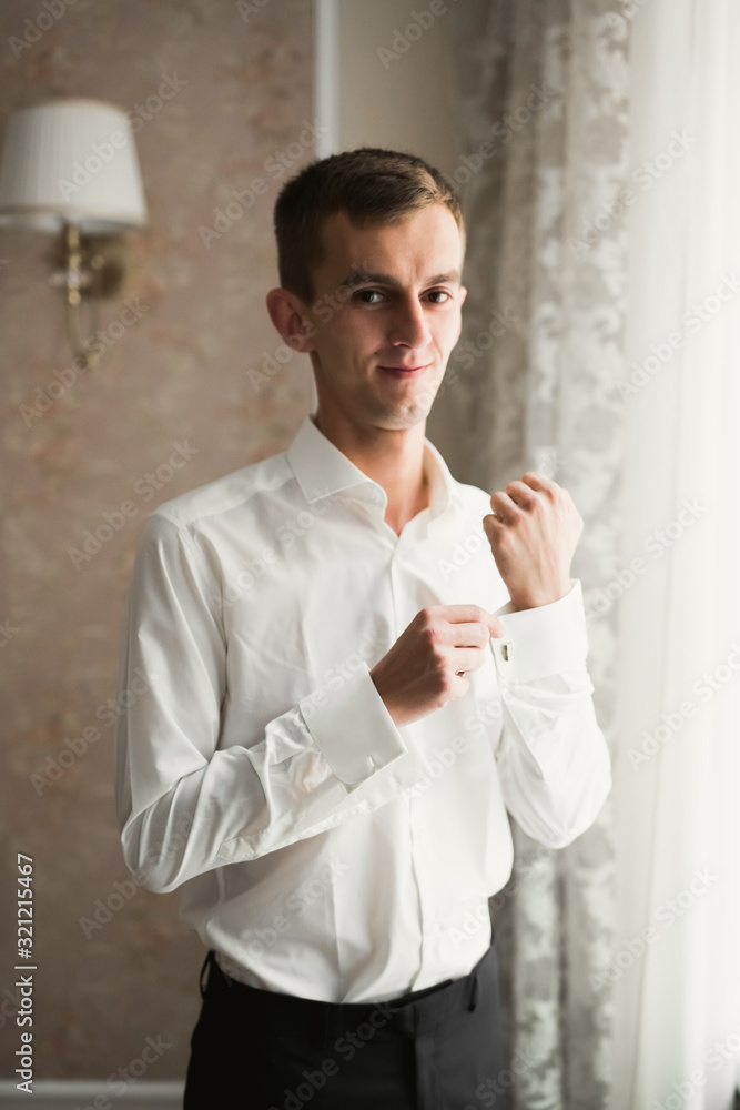 Beautiful man, groom posing and preparing for wedding Beautiful man, groom posing and preparing for wedding