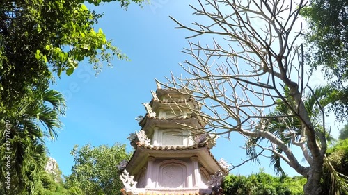 Large Traditional Pagoda Surrounded by Trees and Beautiful Blue Skies. photo