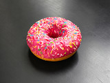American glazed donut on a dark background