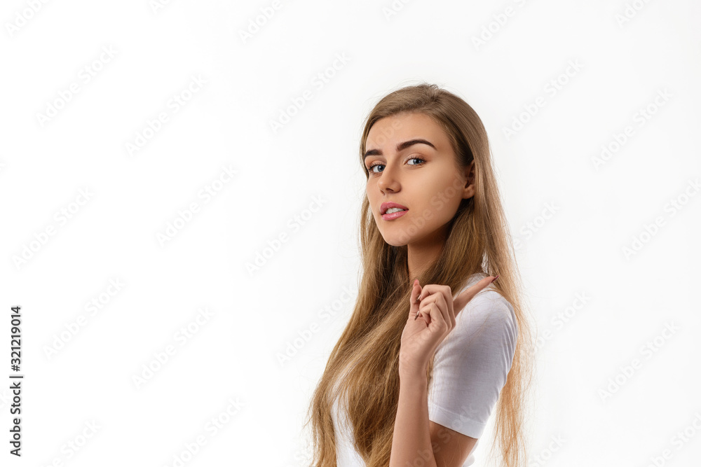 smiling young woman pointing up on white background. smiling young woman pointing up on white background.