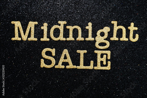Midnight Sale alphabet letter on black glitter background