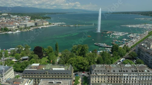 sunny day flight over geneva center cityscape lakeside fountain aerial panorama 4k switzerland