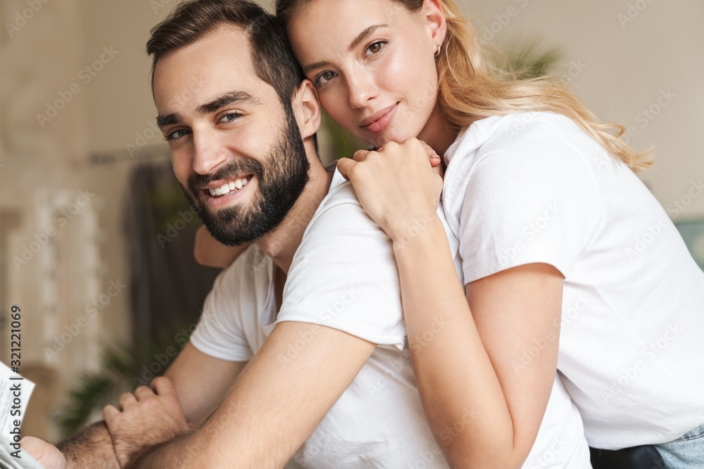 Optimistic loving couple indoors at home. Optimistic loving couple indoors at home.