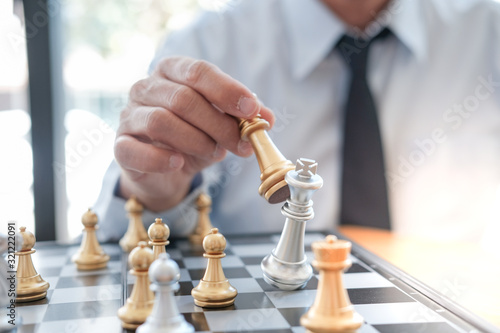 Businessman play with chess game. success management concept of business strategy and tactic challenge.