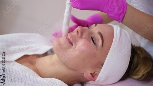 Female cosmetician using liquid nitrogen.