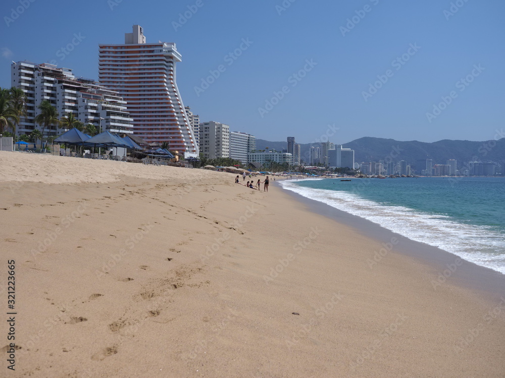Skyscrapers at sandy beach in ACAPULCO city in Mexico at bay of Pacific Ocean