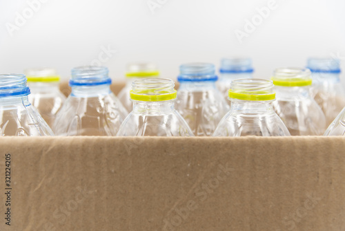 Plastic bottles in paper boxes Recycling concept.