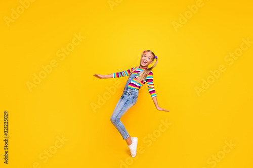 Full size photo of positive cheerful kid enjoy her spring winter weekend holidays feel rejoice wear jumper white shoes isolated over bright color background