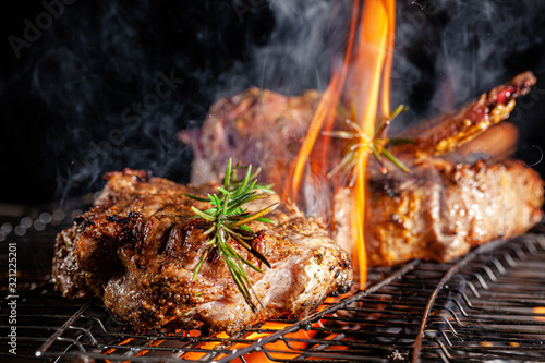 Chef cook fries meat, beef steak on an open fire in a restaurant. background image, copy space text