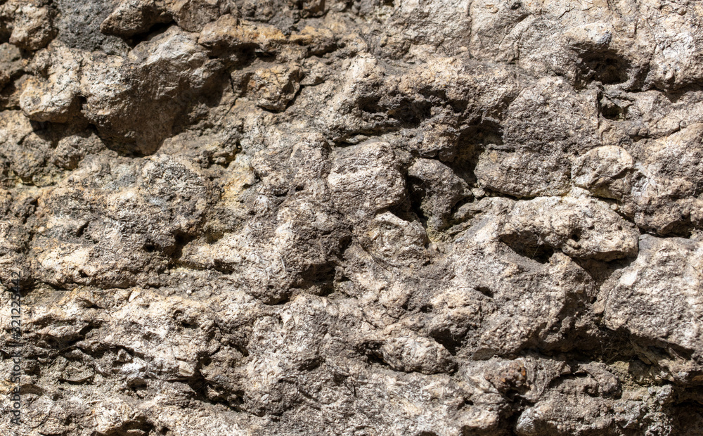 Naklejka premium Stones on the rock as an abstract background