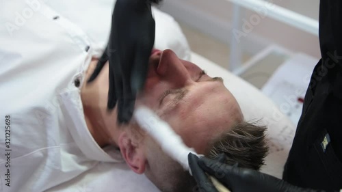 Therapy with liquid nitrogen for the face of a man.