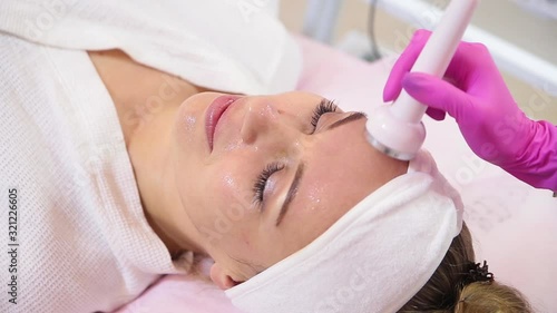 Electric stimulation facial skin care. Microcurrent lift face.