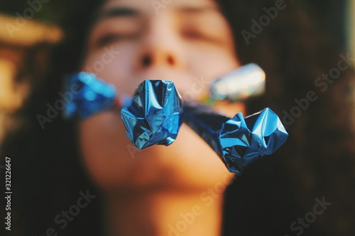 Girl blowing the party poppers