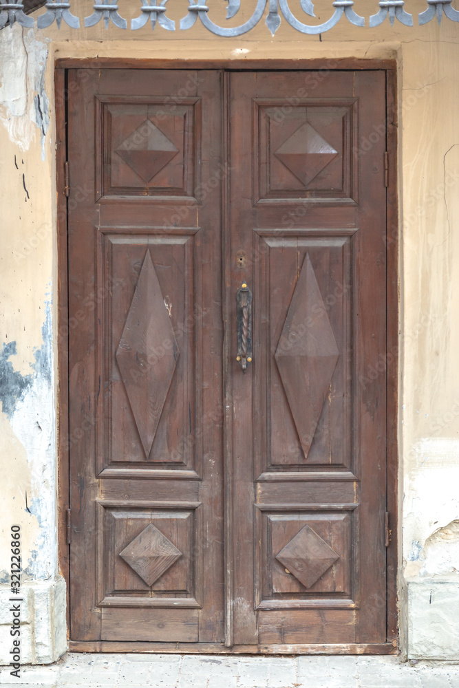 Retro vintage wooden entrance door decorated with geometrical shapes.