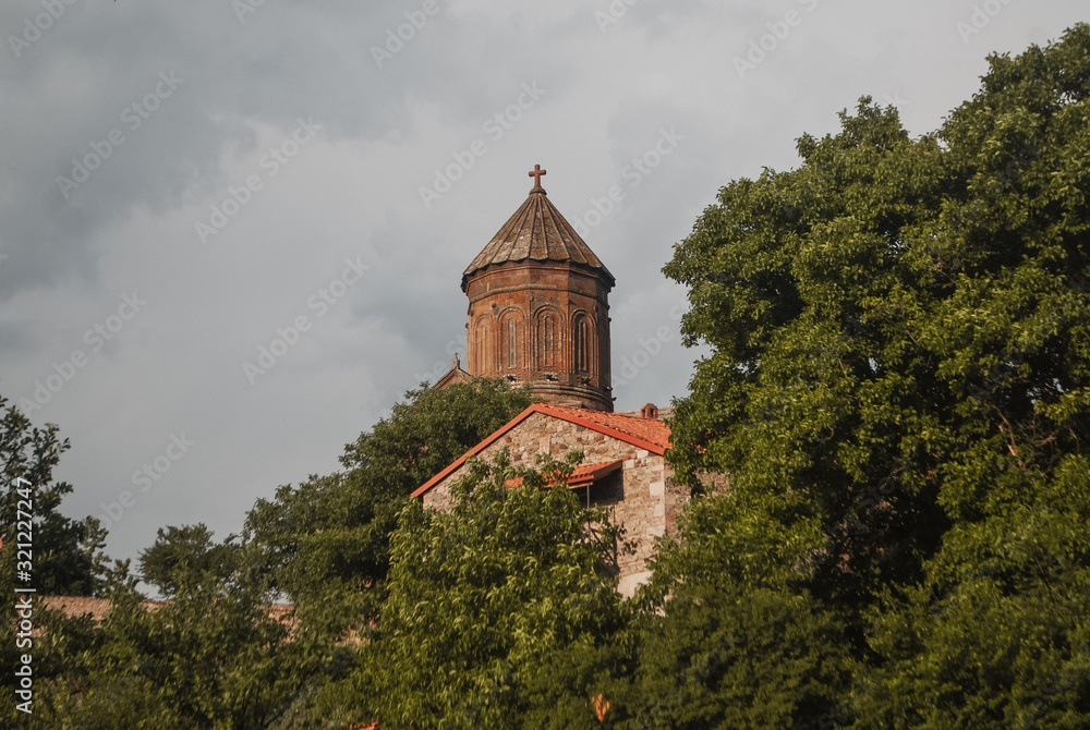 The tower of the temple among the trees, an ancient monastery,