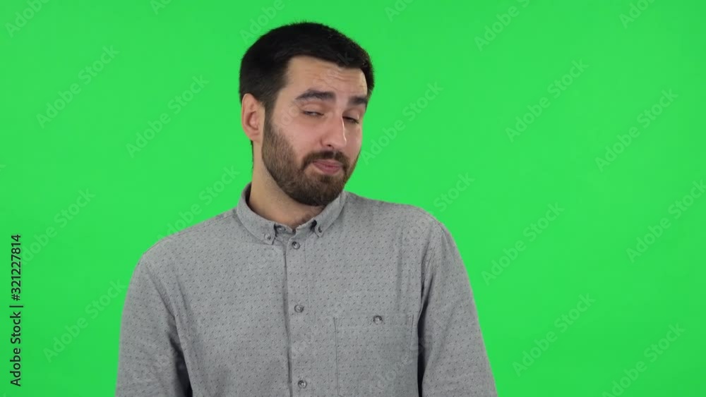Portrait of brunette guy is waiting and yawning with boredom. Green screen Portrait of brunette guy is waiting and yawning with boredom. Green screen