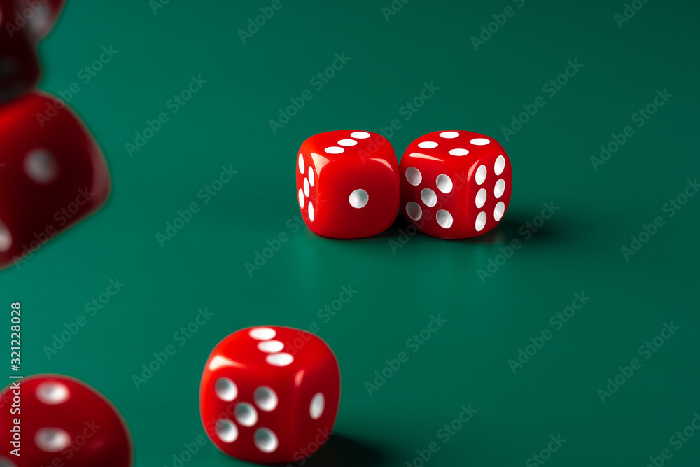 Red dice on green background close up Red dice on green background close up
