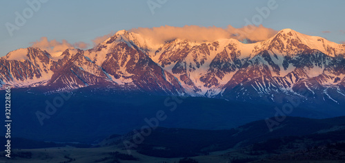 Mountain peaks at sunrise, bright view, panorama nature. Traveling in the mountains, climbing.