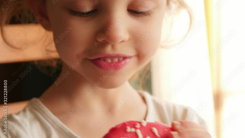 little girl eating red, pink donut, doughnut, macro, close little girl eating red, pink donut, doughnut, macro, close