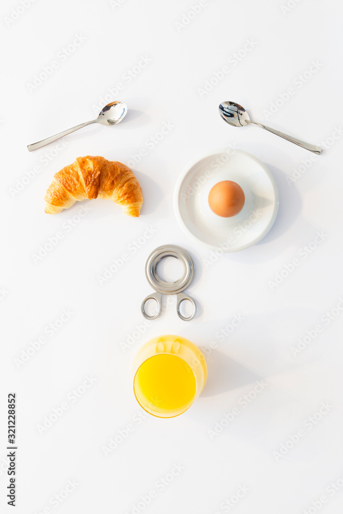 Fototapeta premium Fun breakfast concept with abstract astonished human face made of breakfast items on white background.