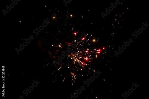 Beautiful new years firework celebration in black evening sky.