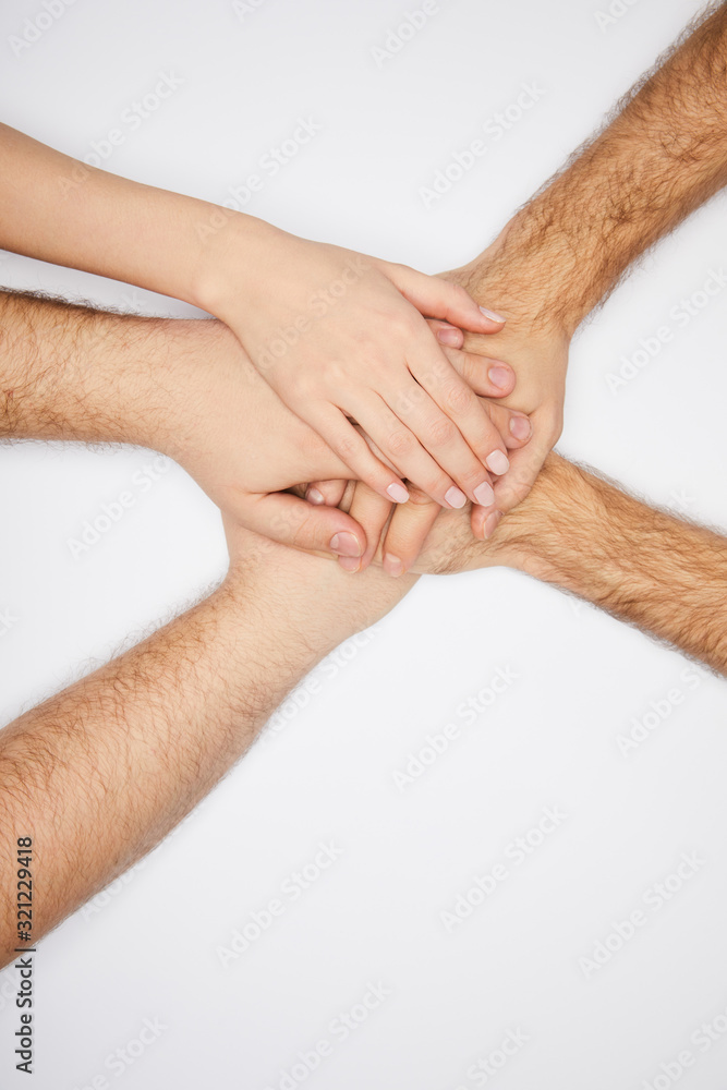 Fototapeta premium top view of men and woman holding hands isolated on white