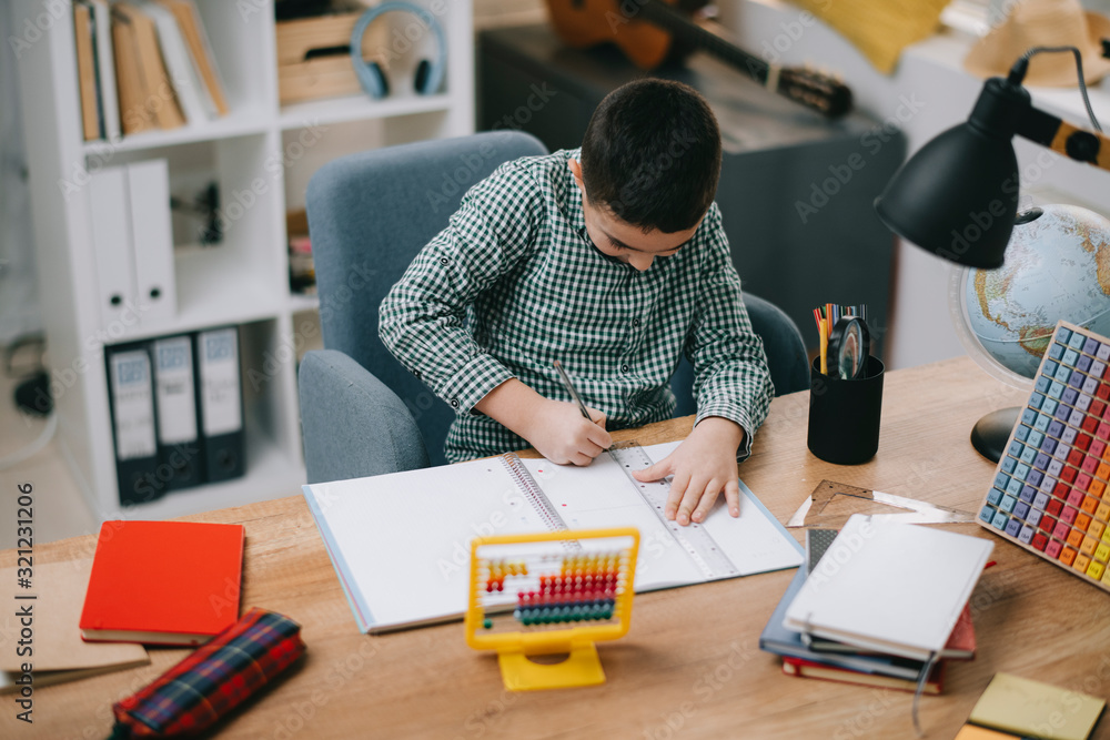 Cute little boy doing homework. Child learning foe school. Cute little boy doing homework. Child learning foe school.