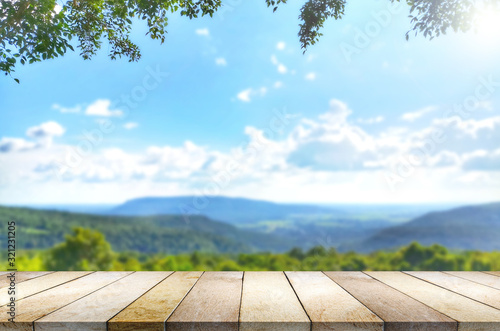 Wooden table against mountain, hill, blurry background. photo