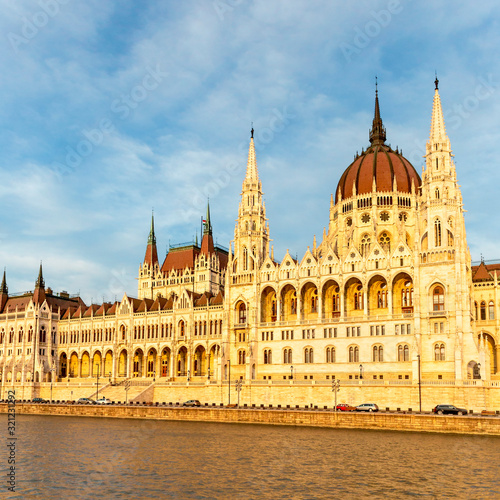 view from the Danube to the famous building of the Hungarian parliament against a beautiful blue sky
