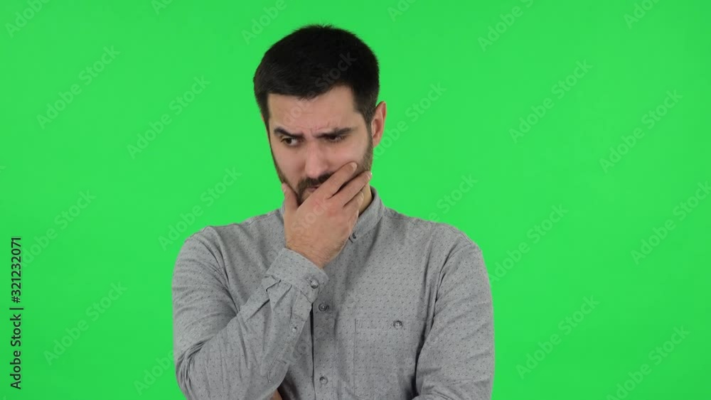 Portrait of brunette guy is thinking about something, and then an idea coming to him. Green screen Portrait of brunette guy is thinking about something, and then an idea coming to him. Green screen