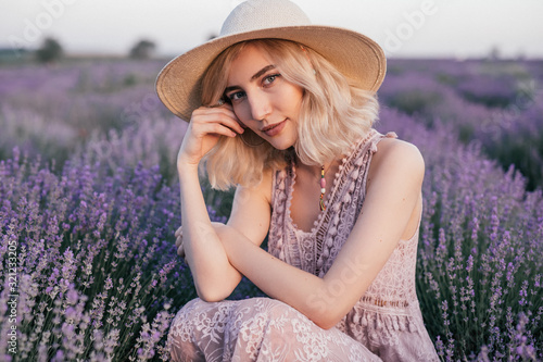 Stylish young female resting in lavender meadow