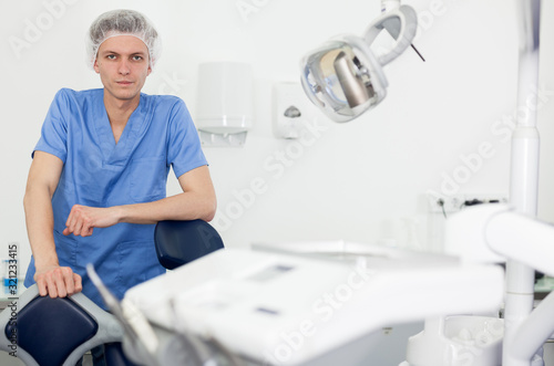 Male dentist is ready to accept client in clinic