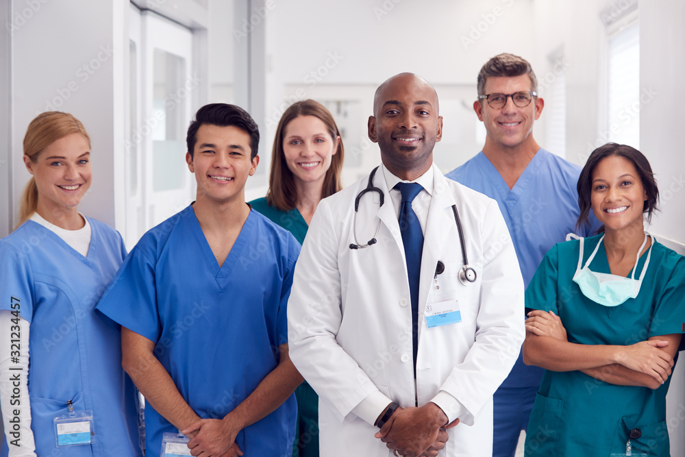 Portrait Of Multi-Cultural Medical Team Standing In Hospital Corridor Portrait Of Multi-Cultural Medical Team Standing In Hospital Corridor