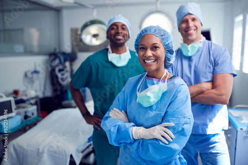 Leinwand Poster Portrait Of Multi-Cultural Surgical Team Standing In Hospital Operating Theater
