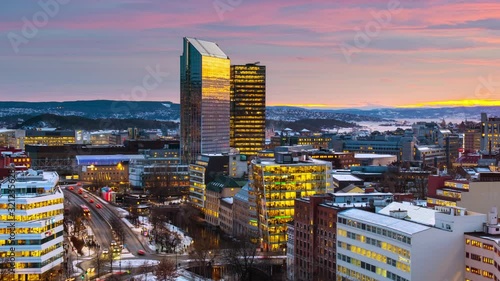 Oslo, Norway. A night view of Sentrum area of Oslo, Norway, with modern and historical buildings and car traffic. Sunset colorful sky in winter with snow, time-lapse with car traffic, panning video photo