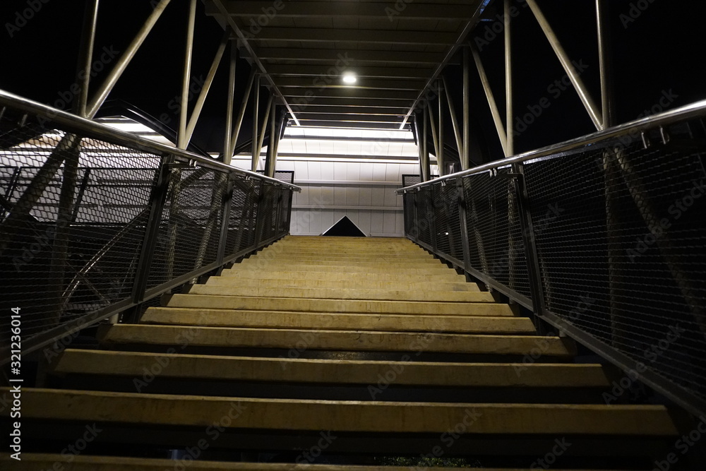 Fototapeta premium look at the stairs from the top corner down at night