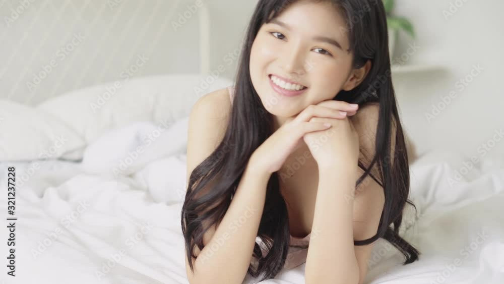 Beautiful portrait young asian sexy woman lingerie lying and smile with wellbeing on the bed, girl in underwear confident in perfect with happy in the bedroom, lifestyle and relax concept. Beautiful portrait young asian sexy woman lingerie lying and smile with wellbeing on the bed, girl in underwear confident in perfect with happy in the bedroom, lifestyle and relax concept.