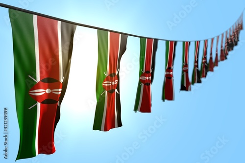 Foto cute many Kenya flags or banners hangs diagonal on string on blue sky background with bokeh - any celebration flag 3d illustration
