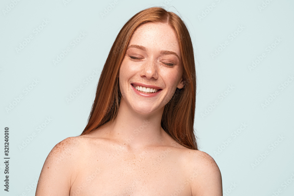 Happy young model with freckles laughing with closed eyes Happy young model with freckles laughing with closed eyes