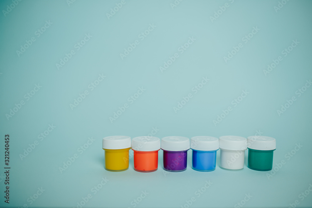 Colorful paints cans on the blue background. Colorful paints cans on the blue background.