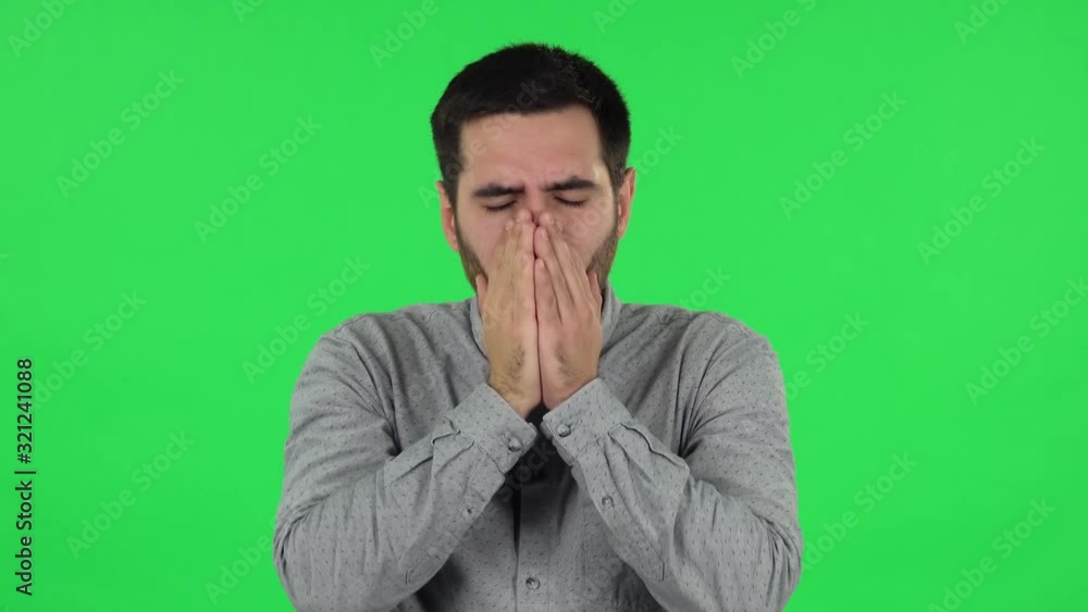 Portrait of brunette guy is getting a cold, sore throat and head, cough. Green screen Portrait of brunette guy is getting a cold, sore throat and head, cough. Green screen