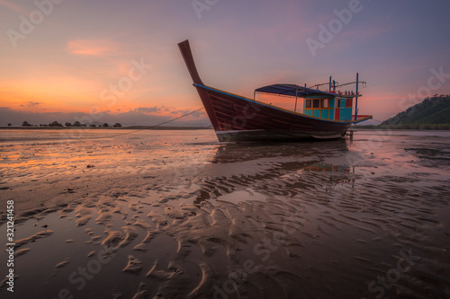 boat on beach at sunset