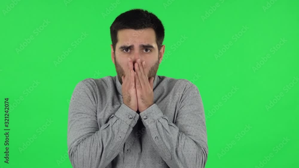 Portrait of brunette guy froze and trying to keep warm. Green screen Portrait of brunette guy froze and trying to keep warm. Green screen