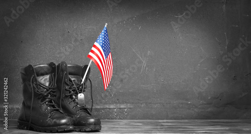 Military combat boots with the American flag and dog tags. Concept - patriotism, protection, remember ,honor ,never forget, thank you photo