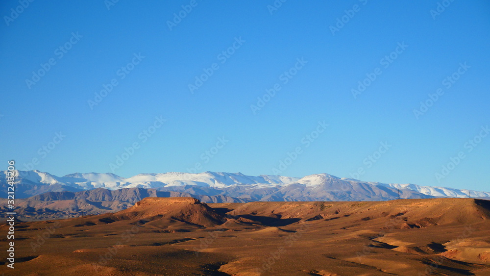 Naklejka premium Bright landscape of Morocco, breathtaking curves of mountains, stunning combination of hills & farm land,inadvertent distribution of houses & huts, raw impression of pure nature.