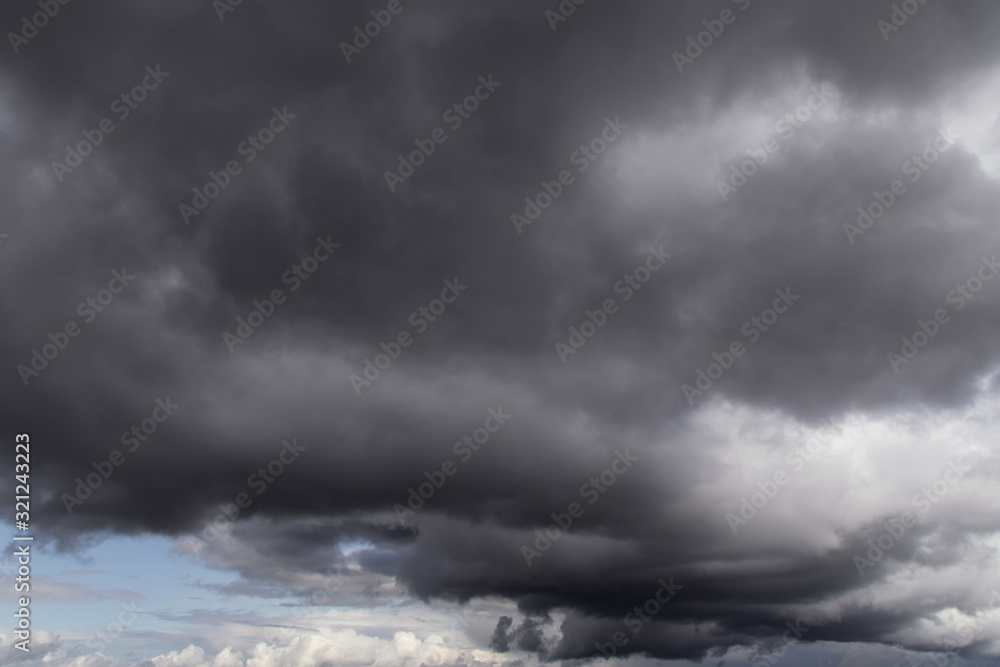 Dramatic storm grey cumulus clouds against blue sky background texture Dramatic storm grey cumulus clouds against blue sky background texture