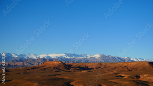 Bright landscape of Morocco  breathtaking curves of mountains  stunning combination of hills   farm land inadvertent distribution of houses   huts  raw impression of pure nature.