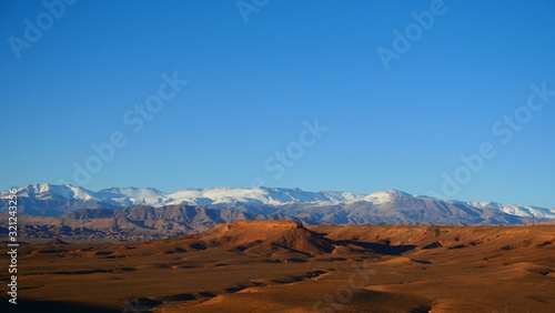 Bright landscape of Morocco  breathtaking curves of mountains  stunning combination of hills   farm land inadvertent distribution of houses   huts  raw impression of pure nature.